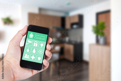 Hand using smartphone to smart home app on mobile for remote control everything in home by wifi network.