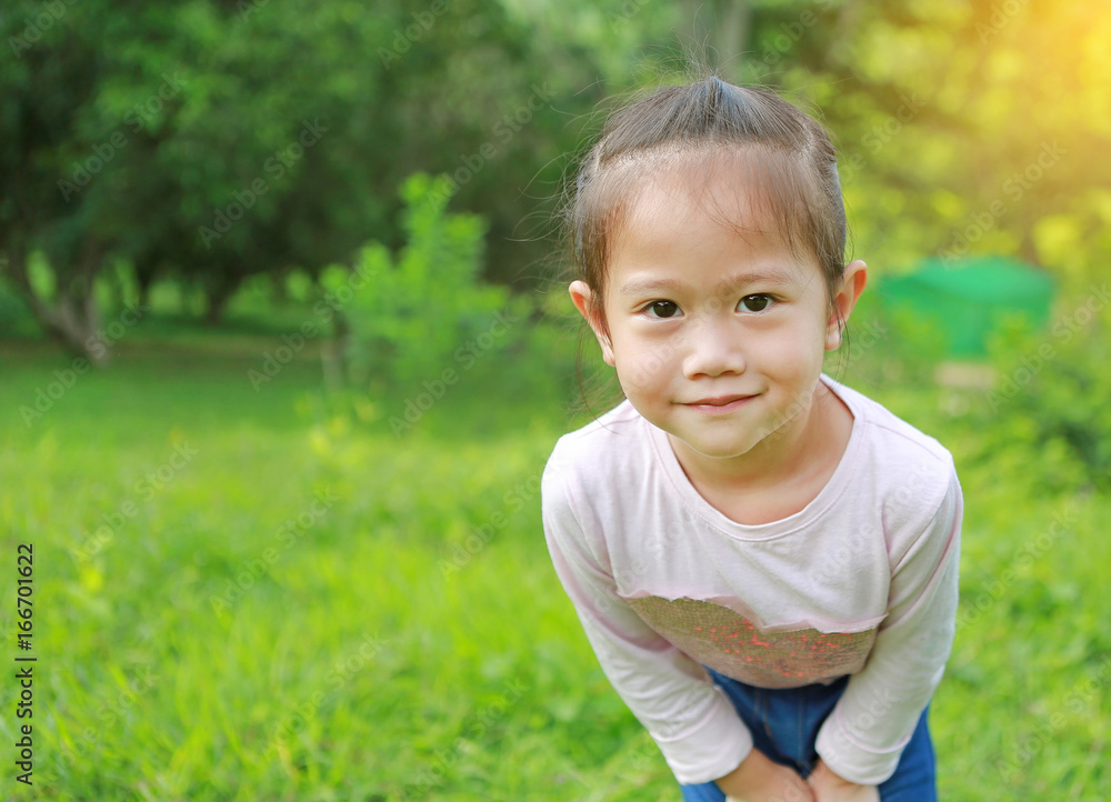 Portrait of little girl posting in the garden. Portrait of little girl posting in the garden.