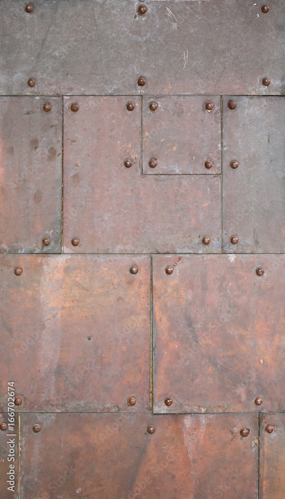 Abstract old copper with rivets as background.