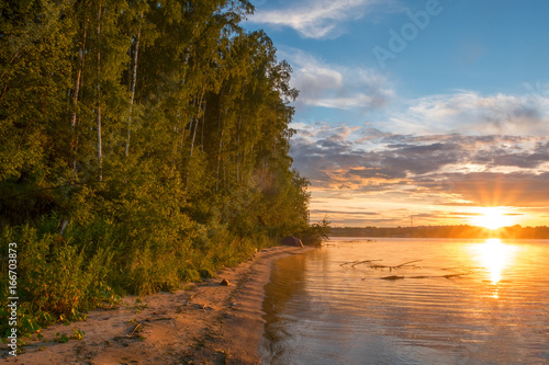 sunset on the river with birch forest