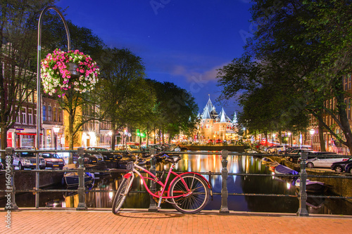 Amsterdam at night, with flowers and bicycles on the bridge, Holland, Netherlands.