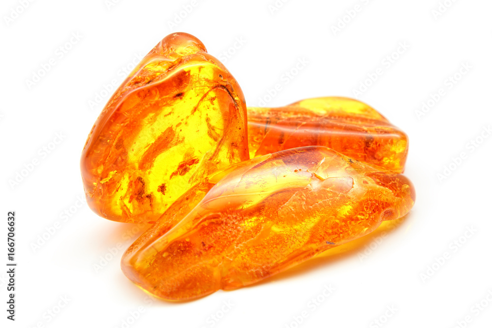 Amber. Bright yellow pieces of amber on a white background. Sunstone amber texture. Mineral for jewelry. Vintage ancient resin. Baltic amber. Colored bright pieces of amber resin