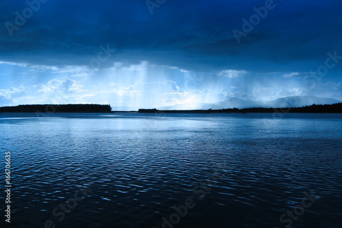 the area between the river  in the light of the divine rays in blue light  the divine rays