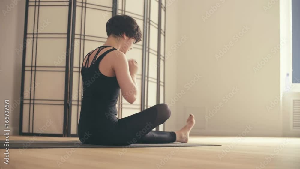 A young woman resting after yoga-asanas A young woman resting after yoga-asanas