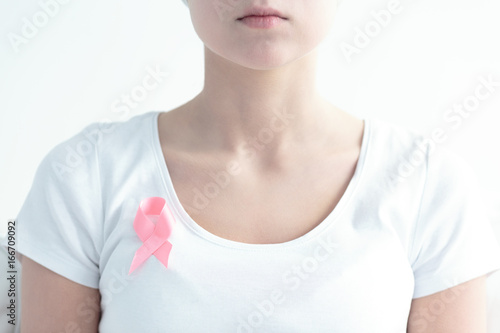 Pink ribbon pinned to chest