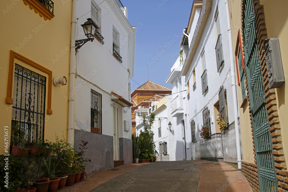 one of the charming streets decorated with flowers in Torrox, Costa del Sol, Spain