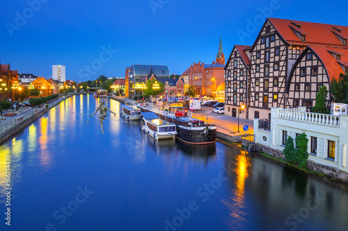 Architecture of Bydgoszcz city with reflection in Brda river at night  Poland