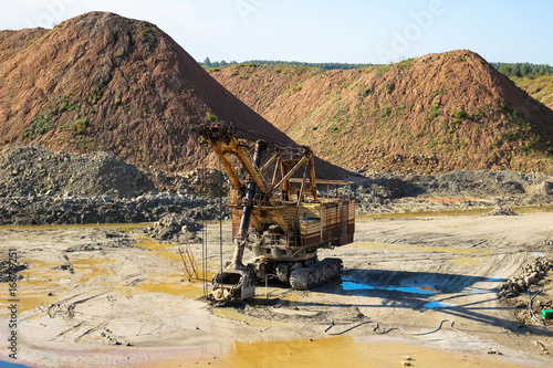 Giant excavator machinery industry. Big mine, develop mineral resources, excavator digs, cement in Lithuania