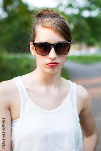 Girl in a White Summer Dress with Sunglasses