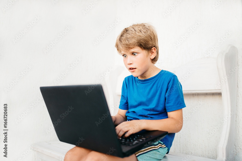 Boy using laptop Boy using laptop