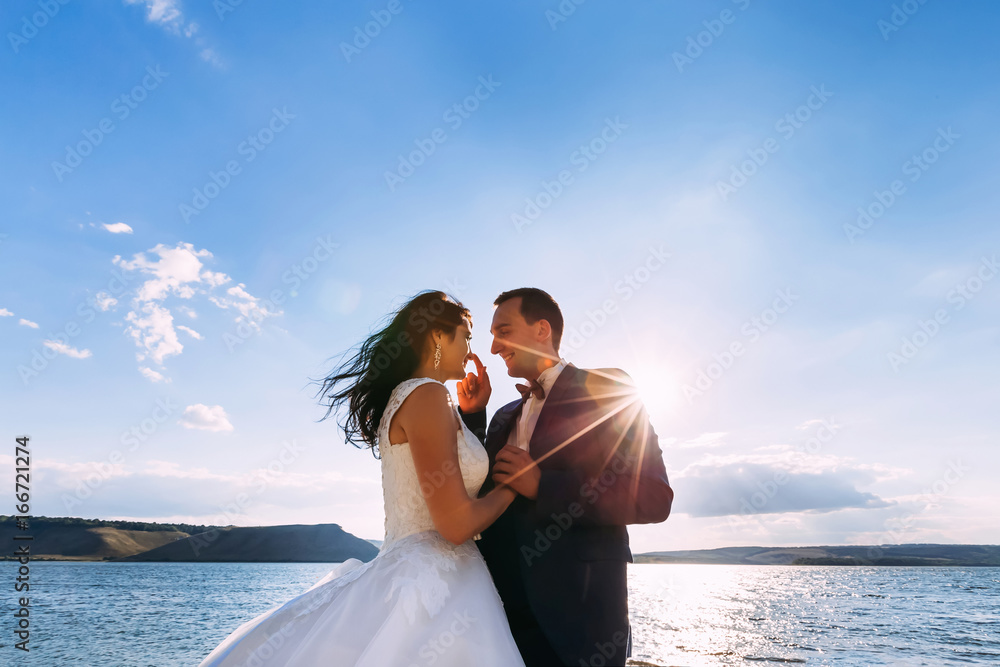 Fantastic wedding couple kissing at the sea. Holidays, vacation,