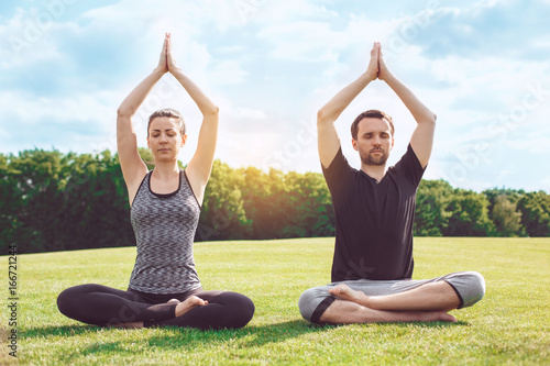 People practice acro yoga outdoors healthy lifestyle