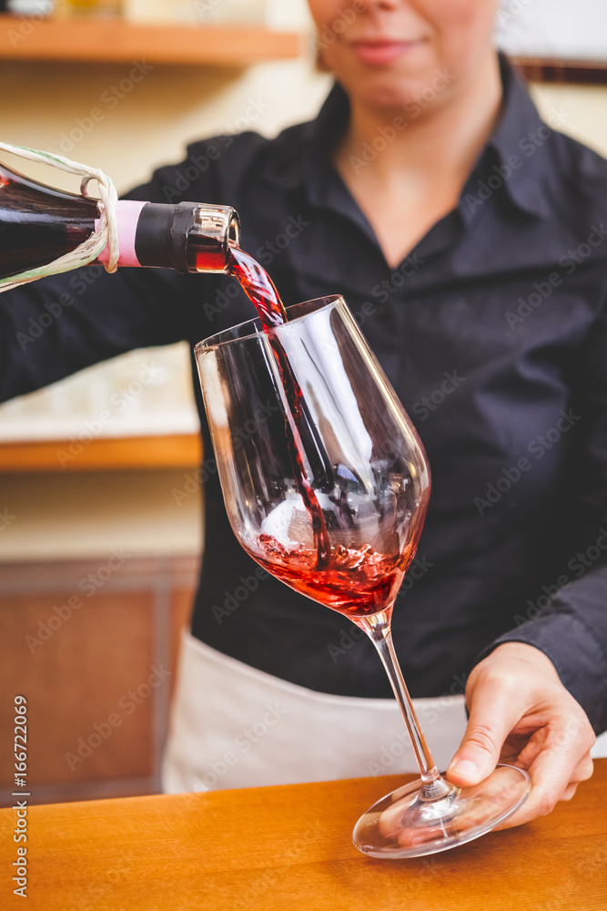 Waitress Pouring Red Wine in a Glass Waitress Pouring Red Wine in a Glass