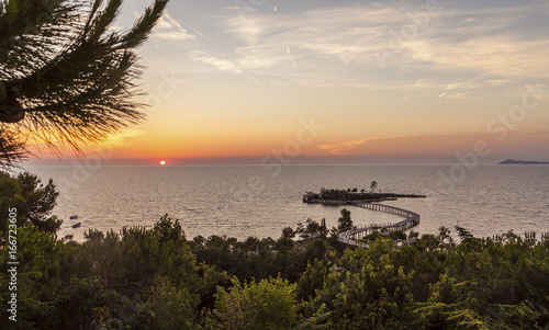 Sunset Seascape with small island at the coast Albania Kavaje Travel Tip Europe