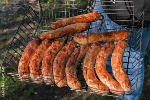 Sausages grilled in nature .