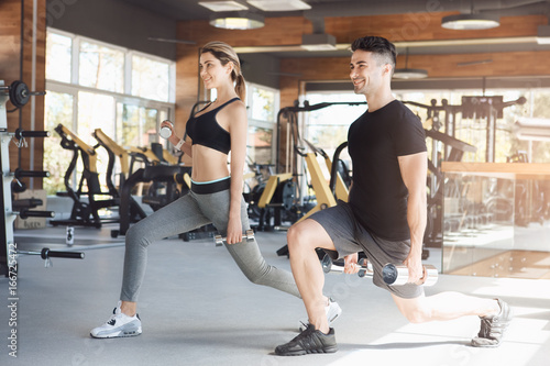 Young couple exercise together in gym healthy lifestyle