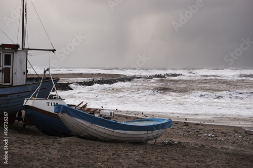fishing boats on the beach during the storm in Nr. Vorupør on the North Sea coast in Denmark