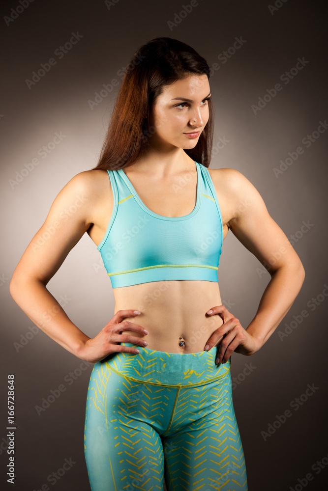 Active young fit woman with perfect body pose