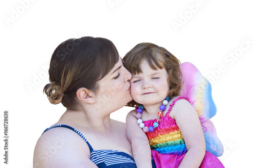 Mother kissing little girl wearing fairy wings/Mother kissing daughter in costume with fairy wings