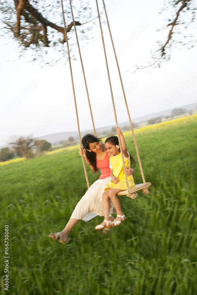 Mother and daughter on a swing Mother and daughter on a swing