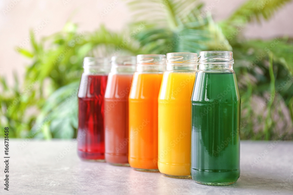 Delicious juices in bottles on table Delicious juices in bottles on table
