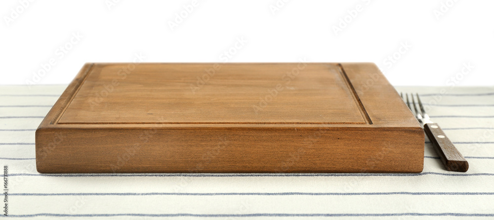 Wooden board and fork on tablecloth against white background
