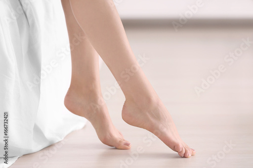 Epilation concept. Female legs on blurred background