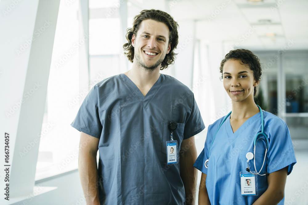 Portrait of Male and Female Nurses in Hospital Hallway Stock Photo