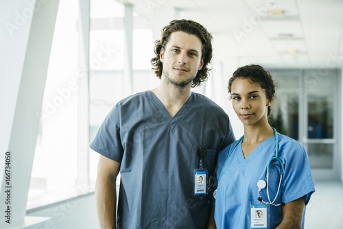 Portrait of Male and Female Nurses in Hospital Hallway