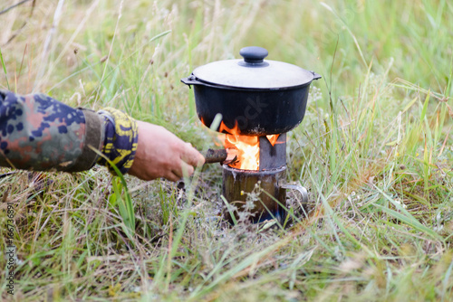 Cooking in the nature using a portable pyrolytic burner oven photo