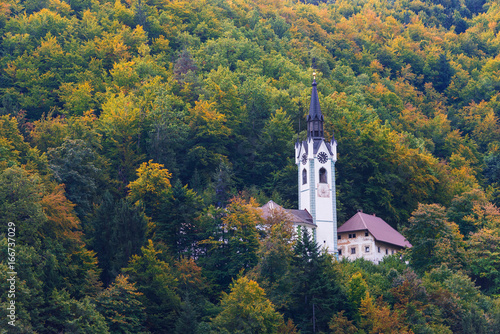 Church surrounded by trees with autumn foliage