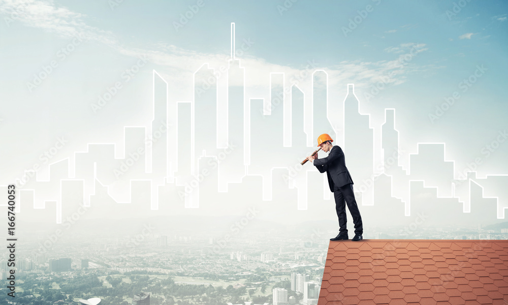 Engineer man standing on roof and looking in spyglass. Mixed med Engineer man standing on roof and looking in spyglass. Mixed med