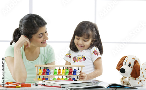 Mother and daughter with an abacus  photo