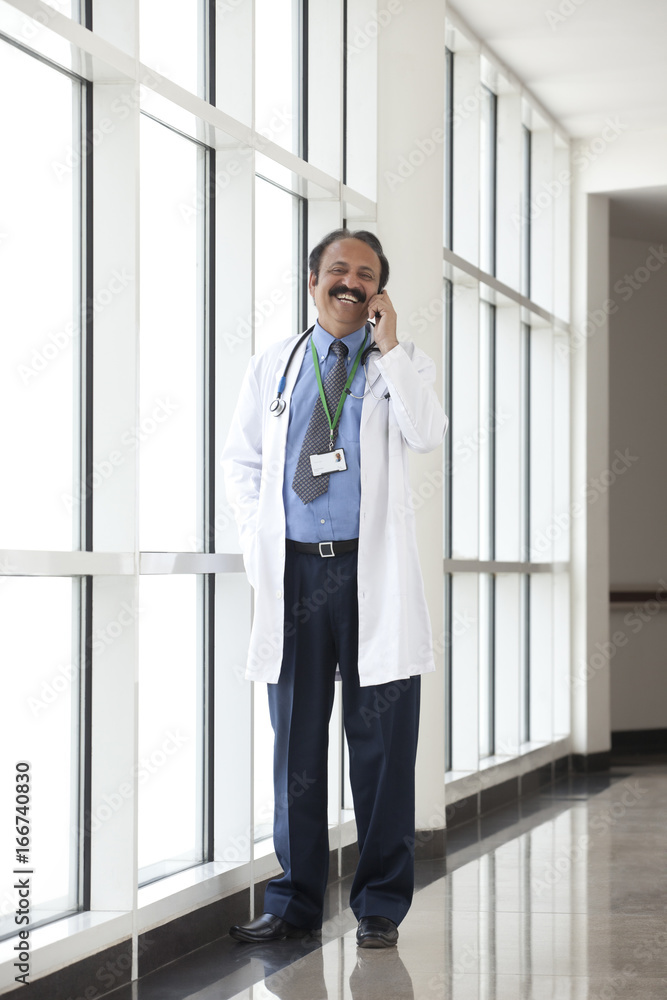 Doctor talking on a mobile phone Doctor talking on a mobile phone
