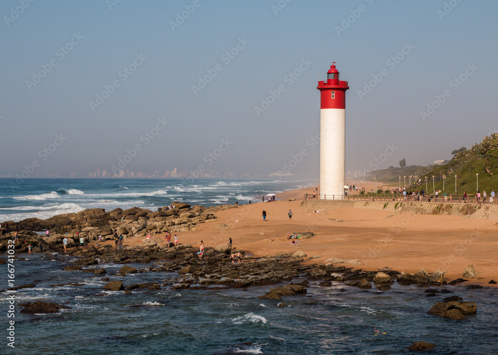 Lighthouse at Umhlanga Rocks in South Africa, landmark coastline landscape.