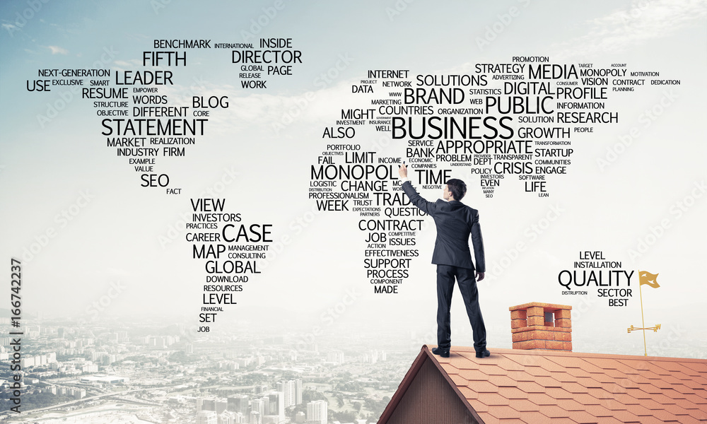 Businessman on brick roof draw world map as concept of globaliza Businessman on brick roof draw world map as concept of globaliza