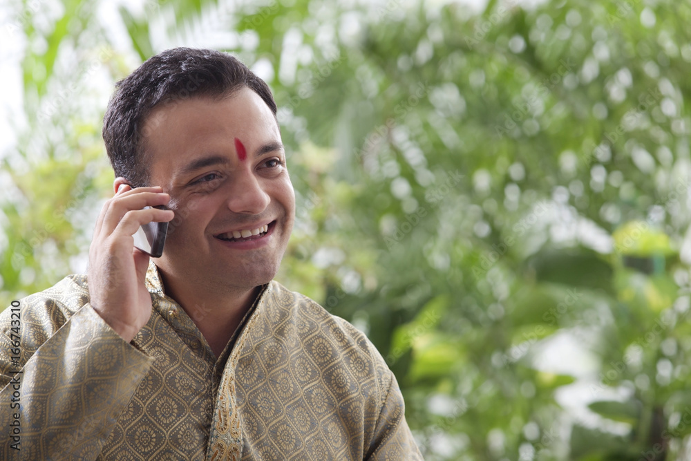 Young man talking on a mobile phone Young man talking on a mobile phone