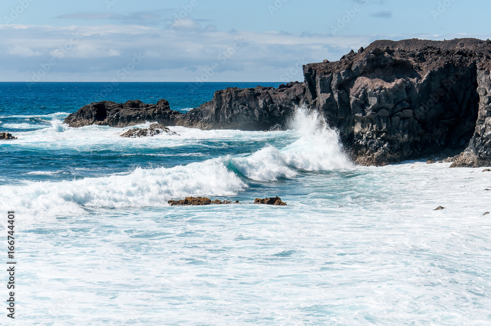 Oceanic waves on Lanzarote volcanic coastline