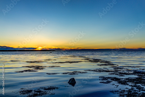 Sunset in Rimouski  Quebec by Saint Lawrence river in Gaspesie region of Canada with seaweed