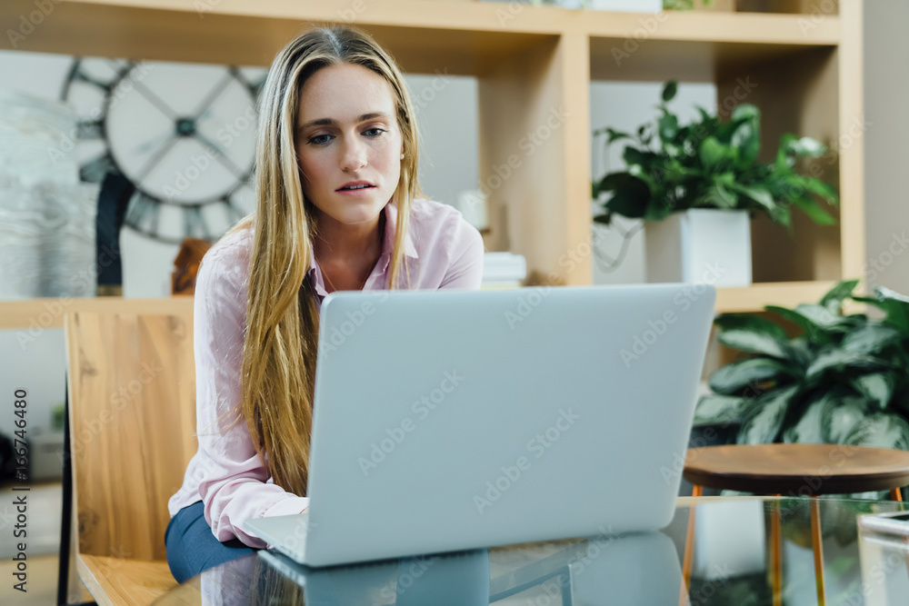 Business woman working on laptop in modern office space Business woman working on laptop in modern office space