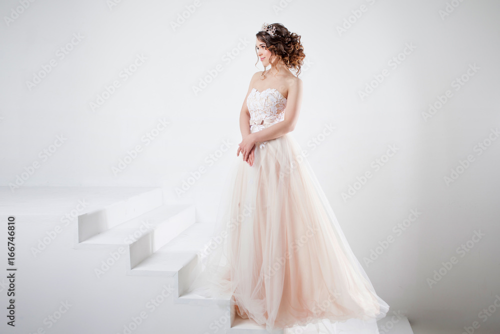 Fototapeta premium Concept of bride going towards future happiness. Portrait of a beautiful girl in a wedding dress.