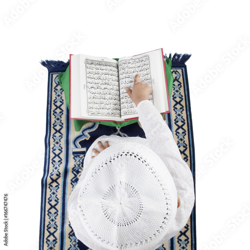 Muslim boy reading the Quran  photo