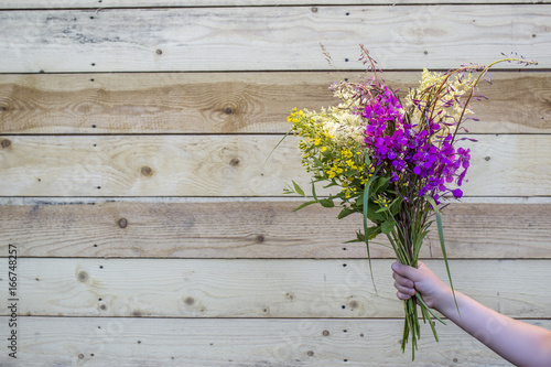 A bouquet of wild wildflowers in hands