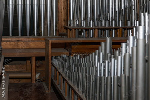 part of the church organ with many air pipes made of metal © murmakova
