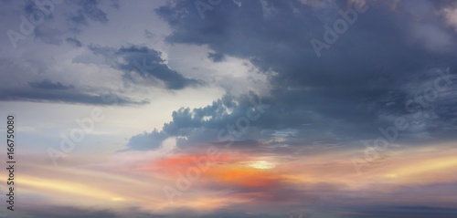 Dramatic colorful sky.  Light in dark sky . beautiful cloud .  Fiery orange sunset sky 