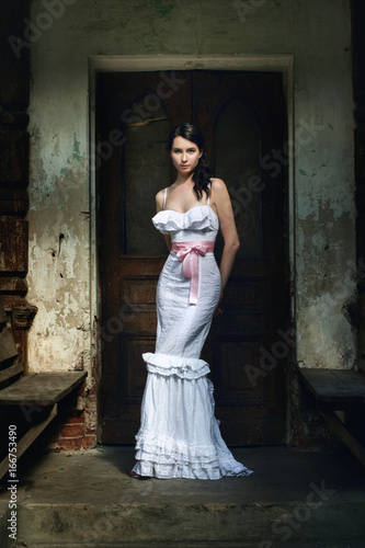 Elegant woman in a stylish long white gown