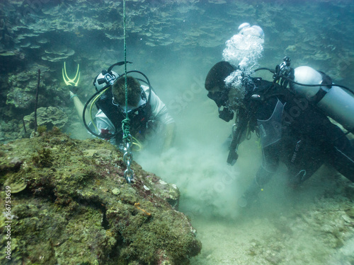 Scuba divers working underwater
