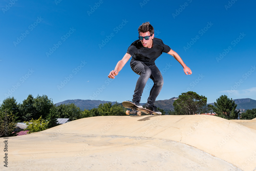 Skateboarder on a pump track park Skateboarder on a pump track park