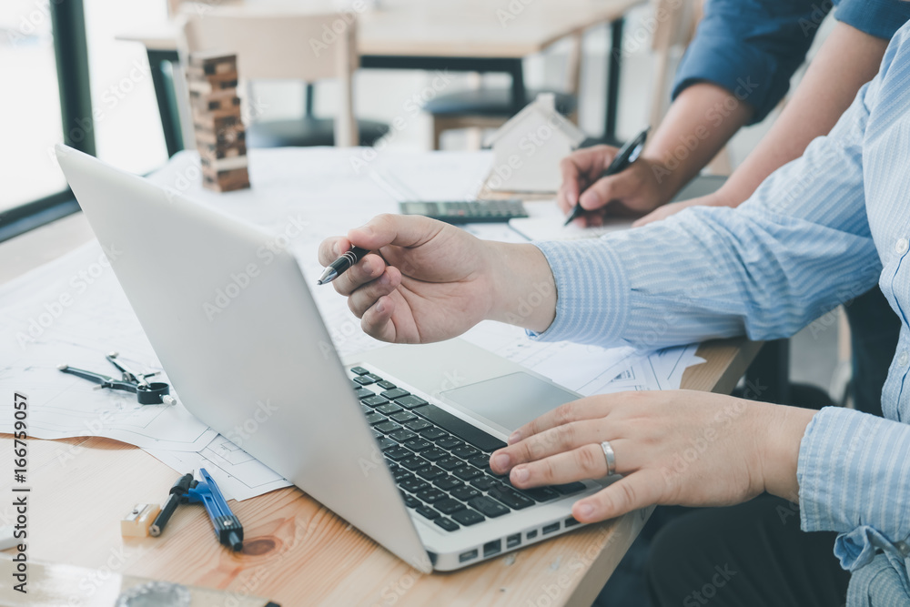 Fototapeta premium Architect or planner working on drawings for construction plans at a table