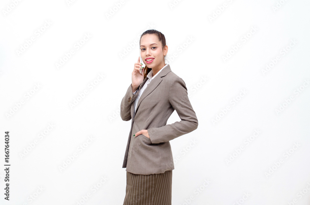 portrait of asian young beautiful smiling business woman standing and talking on her mobile smartphone isolated on white background, lifestyle, business and communication technology concept portrait of asian young beautiful smiling business woman standing and talking on her mobile smartphone isolated on white background, lifestyle, business and communication technology concept